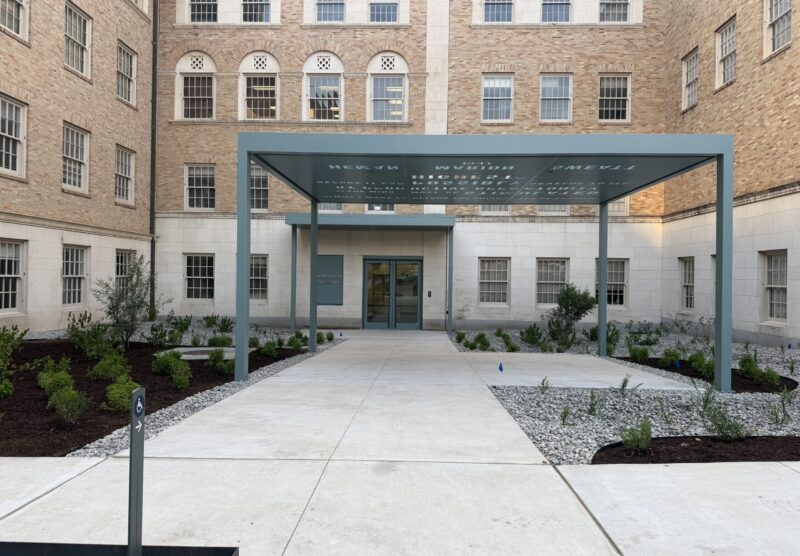 Exterior of an academic building entrance with an extended awning