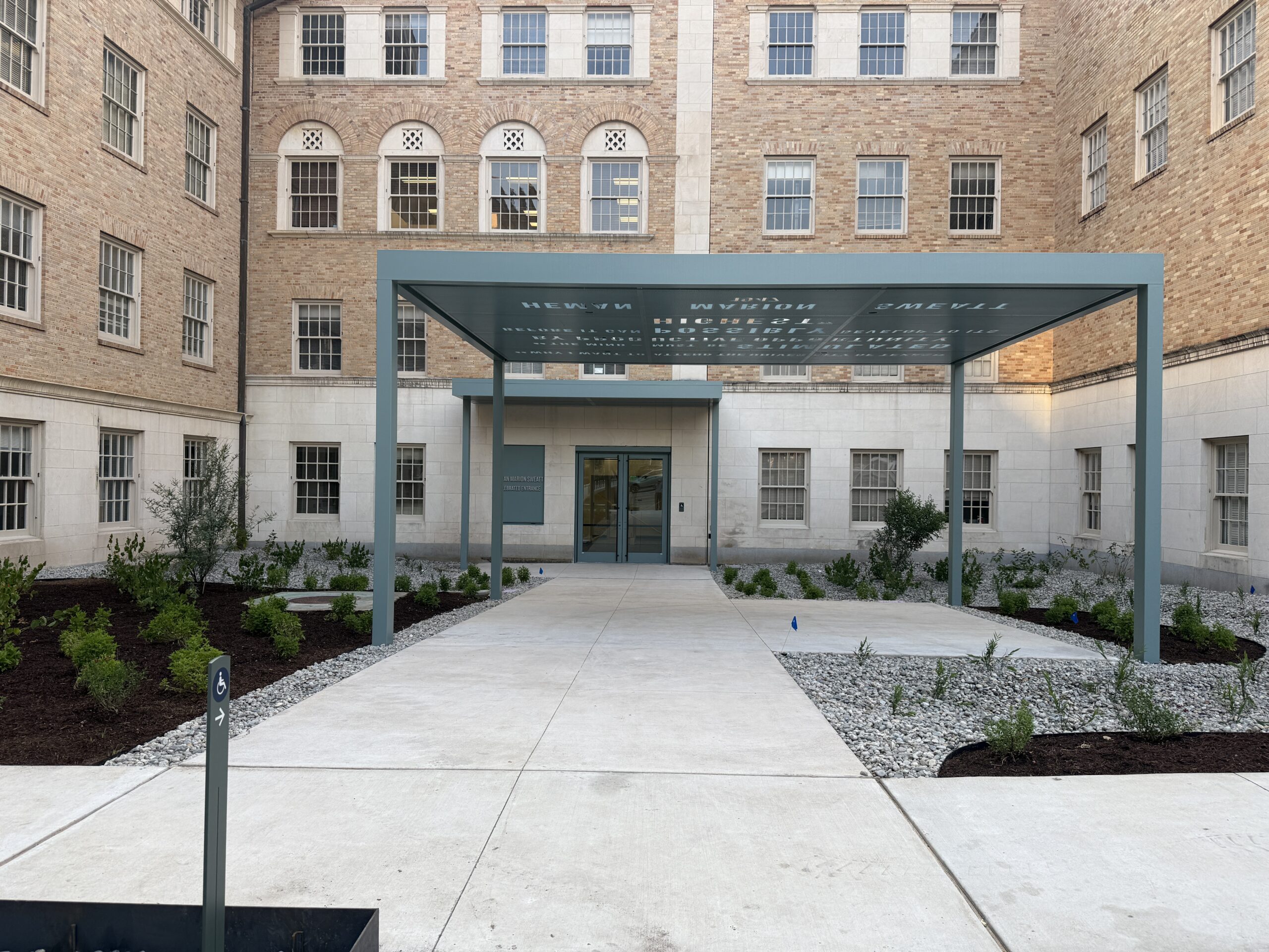 Exterior of an academic building entrance with an extended awning