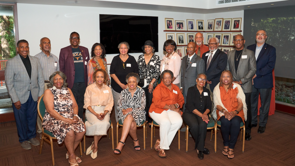 Group of elderly Black people sitting and standing for a group photo.